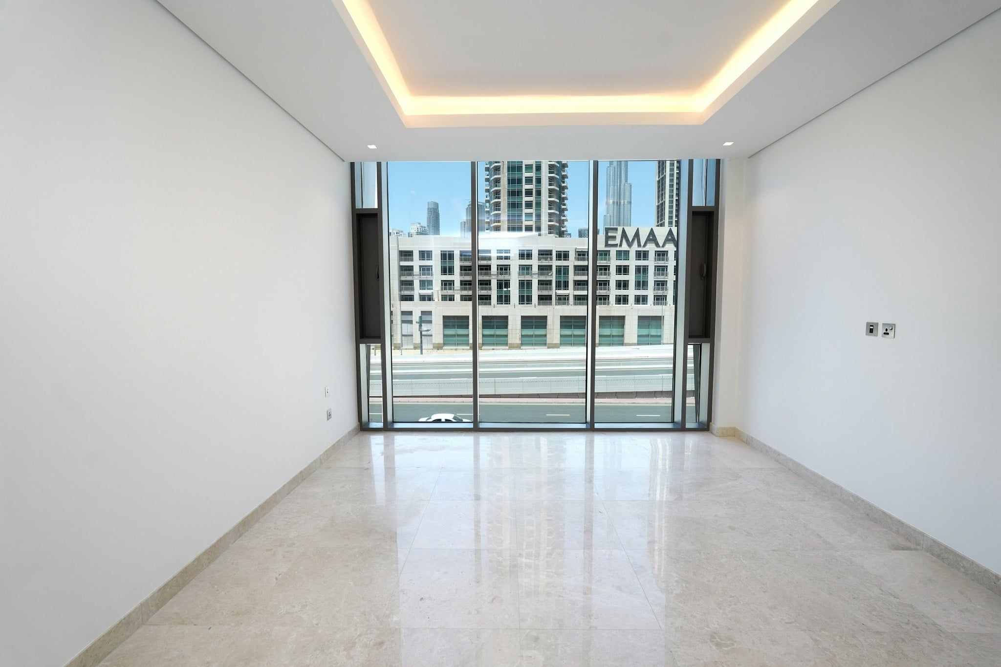 Original photo: empty living room with a marble floor and floor-to-ceiling windows.