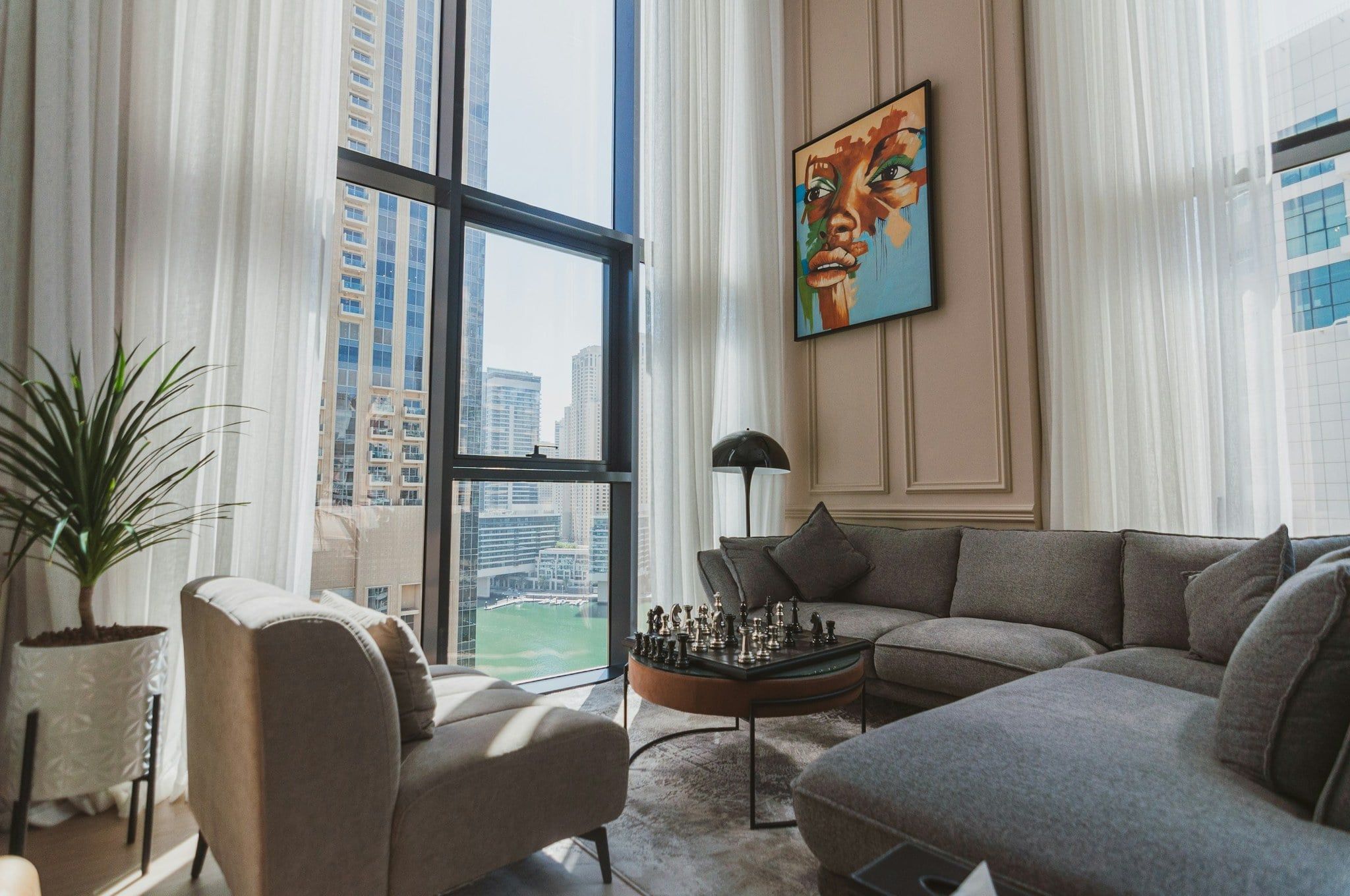 Original photo: living room with tall windows and a pale, washed-out sky.